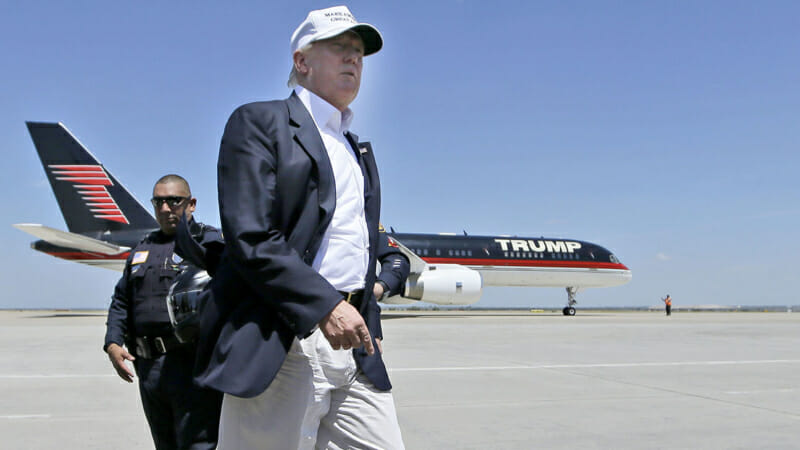 Republican presidential hopeful Donald Trump walks the tarmac before boarding his campaign plane to depart from Laredo, Texas, Thursday, July 23, 2015. (AP Photo/LM Otero)